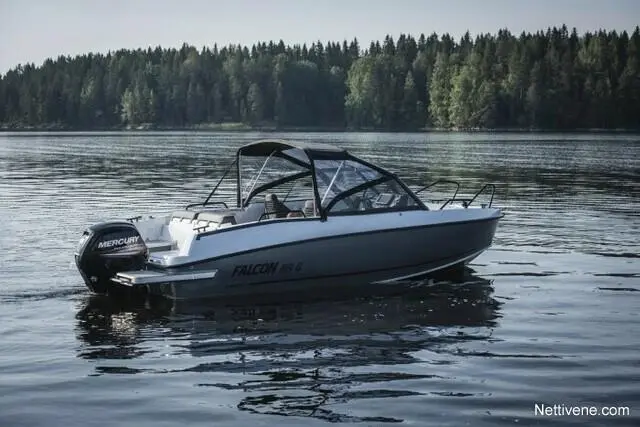 A sleek Falcon 85 G boat with a Mercury outboard motor sits on calm waters, surrounded by a dense forest backdrop.